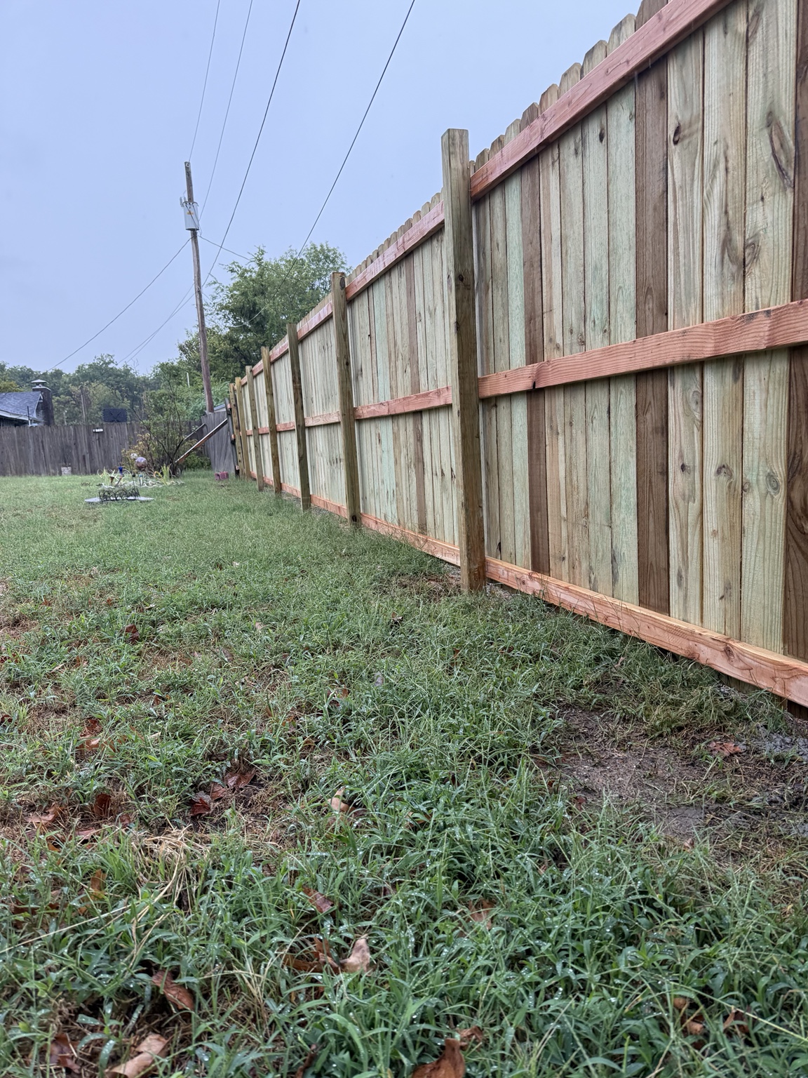 Close perspective of newly installed wood privacy fence