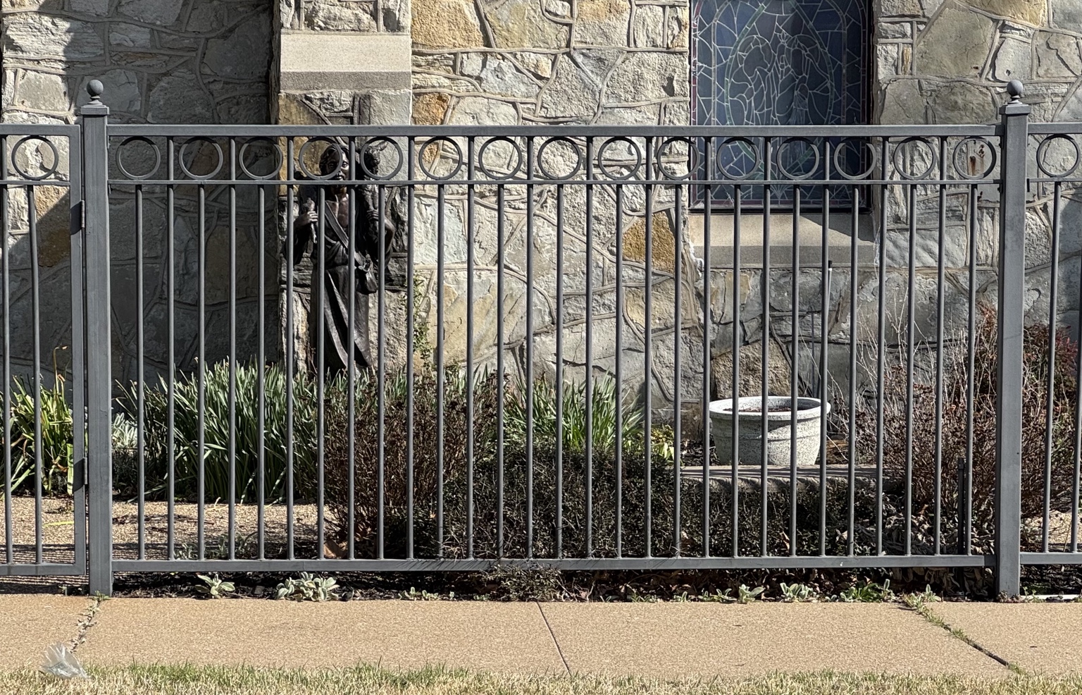 Ornamental steel fence with circular top rail detail