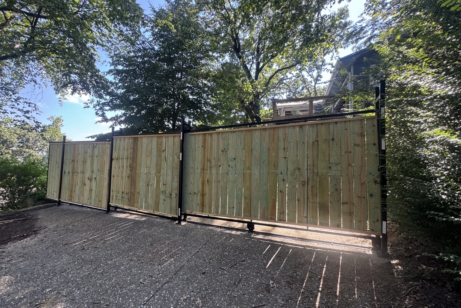 Rear view of a steel framed driveway gate with wood infill